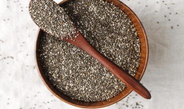 spoon-bowl-full-seeds Chia Seed bowl with wooden spoon on it