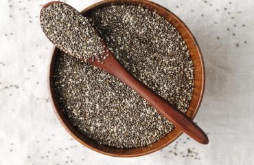 spoon-bowl-full-seeds Chia Seed bowl with wooden spoon on it