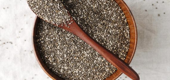 spoon-bowl-full-seeds Chia Seed bowl with wooden spoon on it